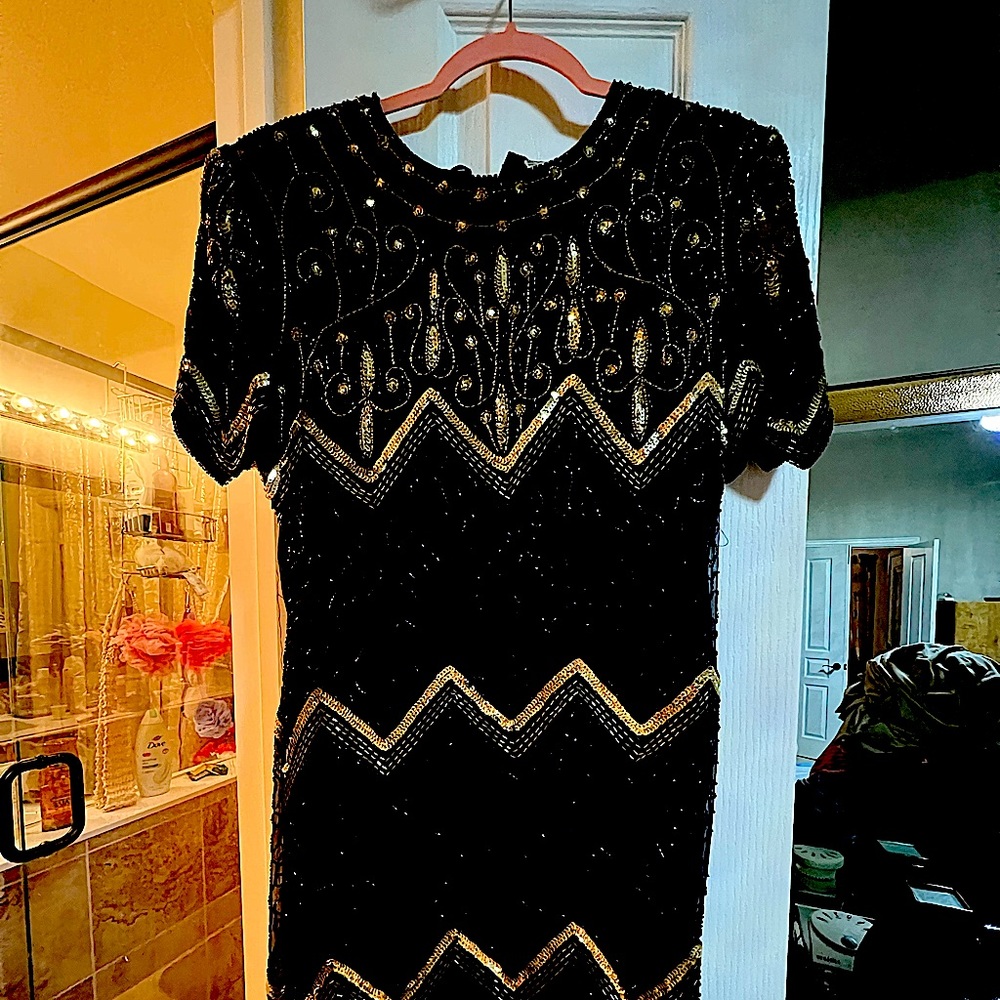 Beautiful just above the knee black cocktail dress with gold sequins.